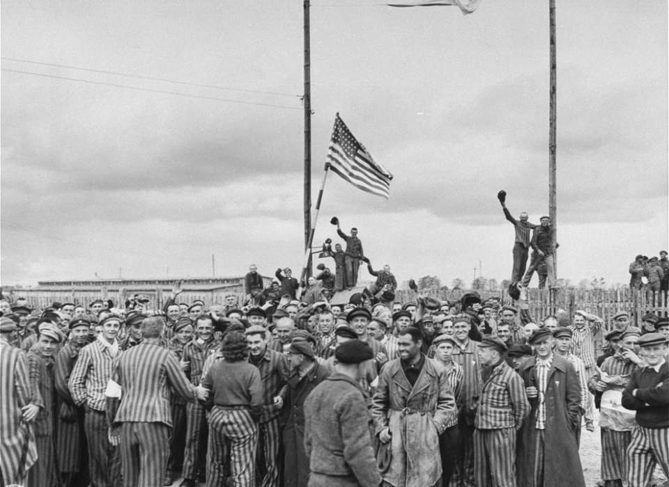 Inmates waving a home-made American flag greet U.S. Seventh Army troops