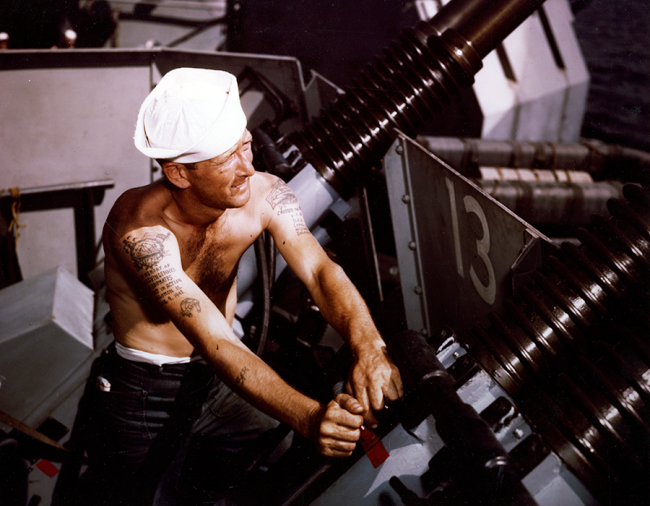 Charles J. Hansen working on a 40mm quad machine gun