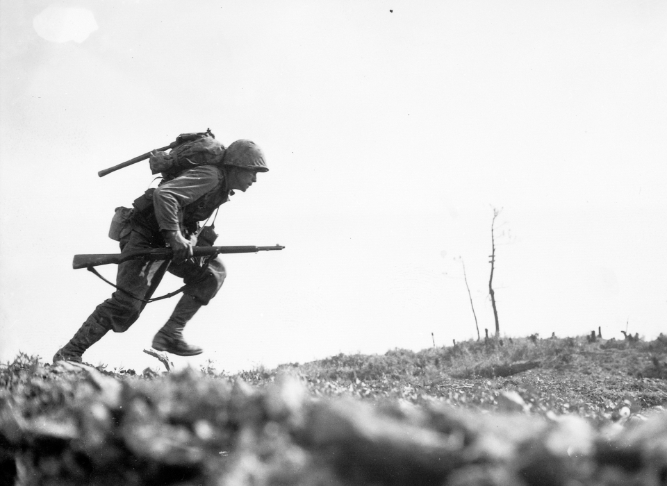 A Marine dashes through Japanese machine gun fire